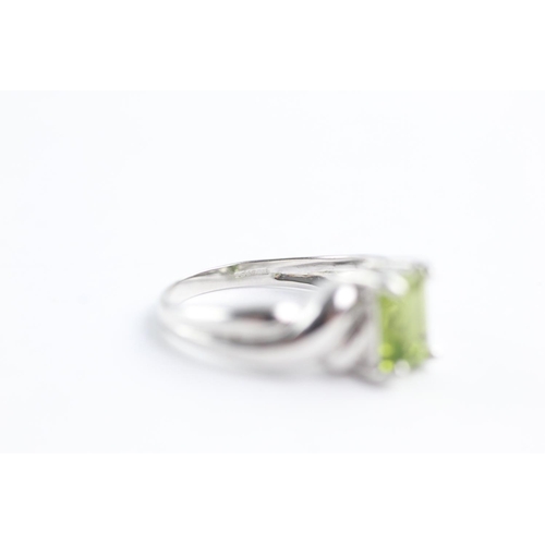 110 - 9ct white gold peridot dress ring (4.1g) Size N