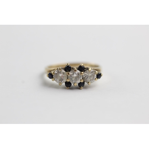 202 - 9ct gold sapphire and clear gemstone dress ring (2.6g) Size O