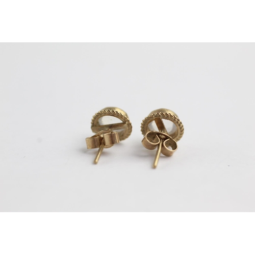 218 - 9ct gold moonstone rope framed stud earrings (1.3g)