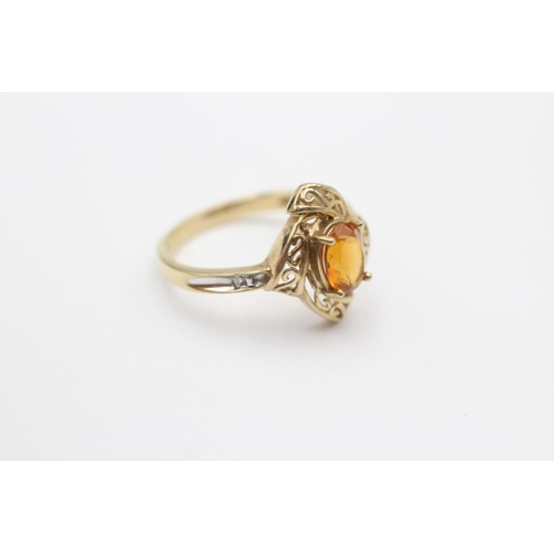 261 - 9ct gold swirl framed citrine ring (2.4g) Size N