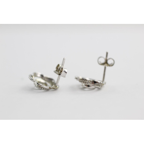 294 - 9ct white gold diamond floral studs (1.1g)