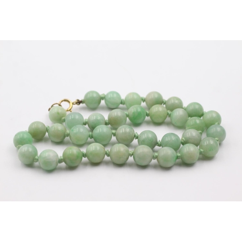 216 - 9ct gold clasped jade bead necklace (54.1g)