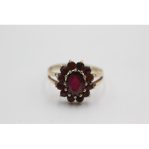 106 - 9ct gold garnet halo set ring (2.5g)  Size Q