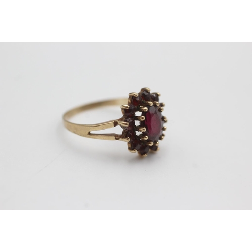 106 - 9ct gold garnet halo set ring (2.5g)  Size Q