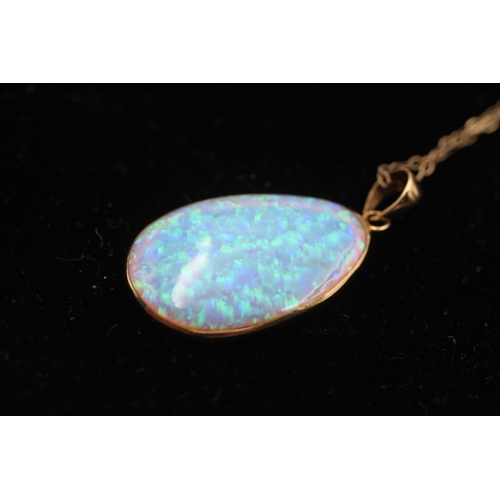 154 - 14ct gold framed opal pendant on chain (2.9g)