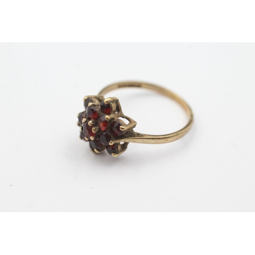 244 - 9ct gold garnet floral set ring (2.5g)  Size Q