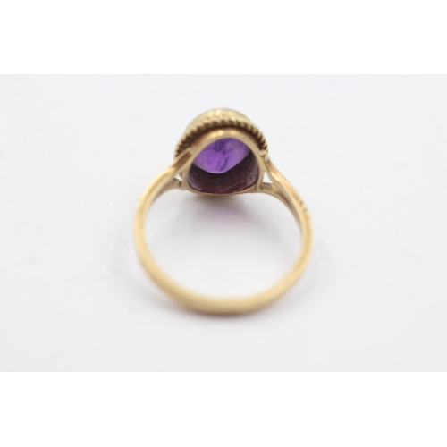 255 - 9ct gold amethyst rope framed ring (2.8g)  Size  M