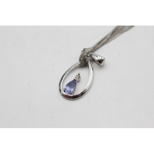 287 - 9ct white gold tanzanite & diamond pendant on chain (1.1g)