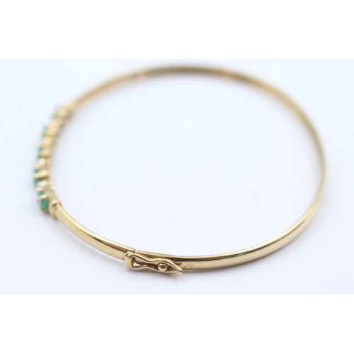 349 - 9ct gold emerald & diamond fronted bangle (4.5g)