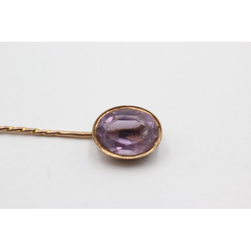 55 - 15ct gold head antique amethyst stick pin with 9ct gold pin (2.1g)