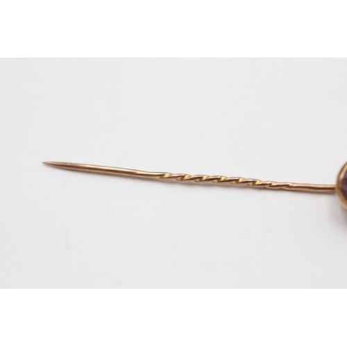 55 - 15ct gold head antique amethyst stick pin with 9ct gold pin (2.1g)