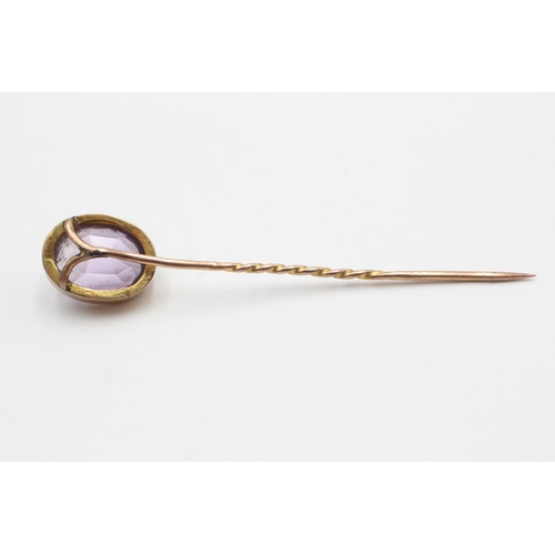 55 - 15ct gold head antique amethyst stick pin with 9ct gold pin (2.1g)