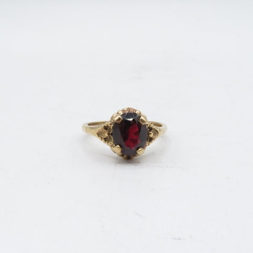 70 - 9ct gold garnet solitaire ring with textured frame (2.9g) Size   O