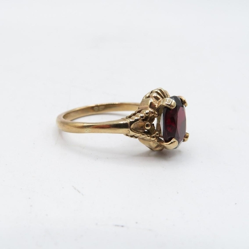 70 - 9ct gold garnet solitaire ring with textured frame (2.9g) Size   O