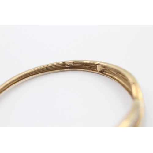 45 - 9ct gold sapphire & diamond twist band round bangle (10.5g)