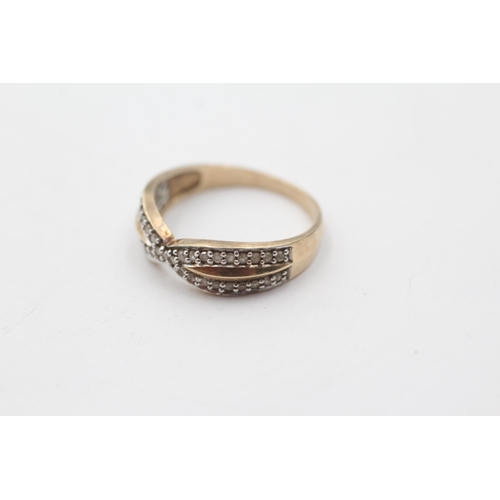 109 - 9ct gold diamond crossover ring (2.5g) size  P