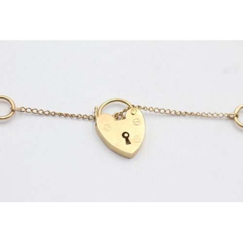 16 - 9ct gold heart-shaped garnet fancy link bracelet with heart padlock (14.5g)