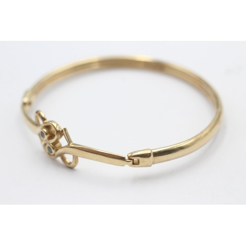 165 - 9ct gold topaz double heart openwork bangle by clogau (12.1g)