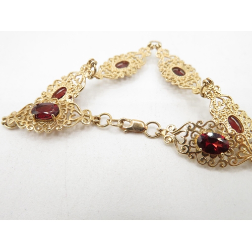 203 - 9ct gold heart fretwork panel bracelet with garnet inserts   7