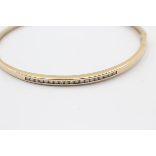 31 - 10ct Gold Diamond Channel Set Half Eternity Hinged Bangle Bracelet (7.5g)