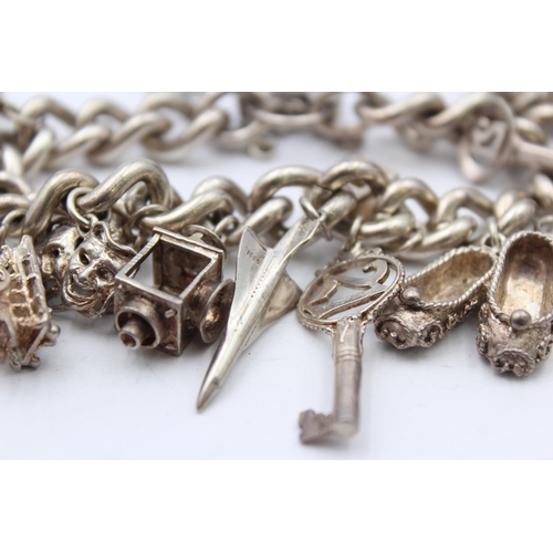 156 - A Vintage Silver Charm Bracelet With Assorted Charms (110g)