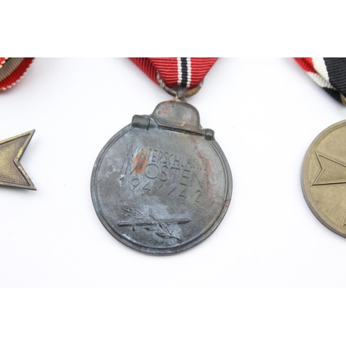 202 - 3x German WWII medals including Merit Cross, Merit Medal and Eastern Front Medal.