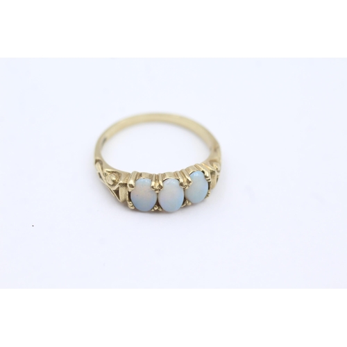 62 - 9ct Gold White Opal Three Stone Ring (2.2g) size  M