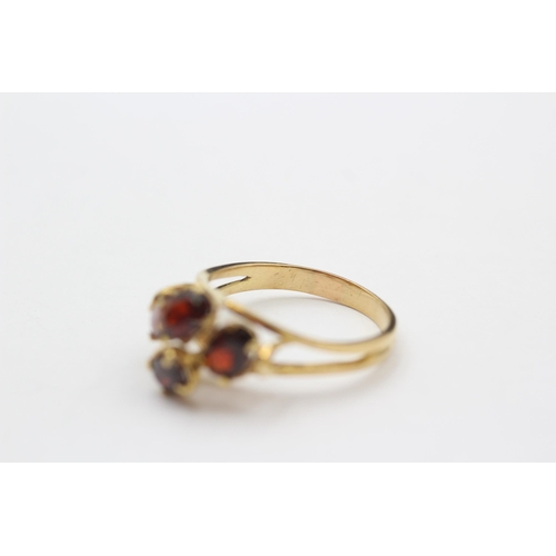 127 - 18ct Gold Garnet Four Stone Dress Ring (3.9g) size P