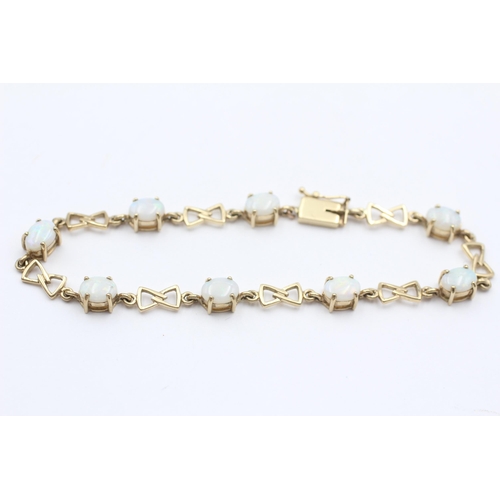 134 - 9ct Gold Opal Oval Cut And Bow Links Fancy Chain Bracelet (7.9g)