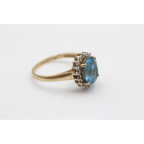 66 - 9ct Gold Blue Topaz & Diamond Halo Dress Ring (3.5g) size Q1/2