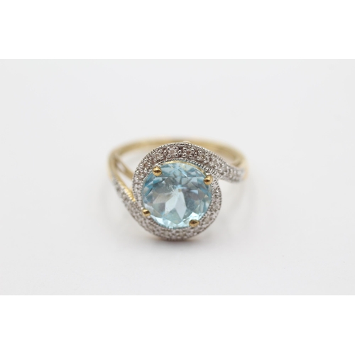 68 - 9ct Gold Blue Topaz & Diamond Halo Twist Setting Ring (3.8g) size Q