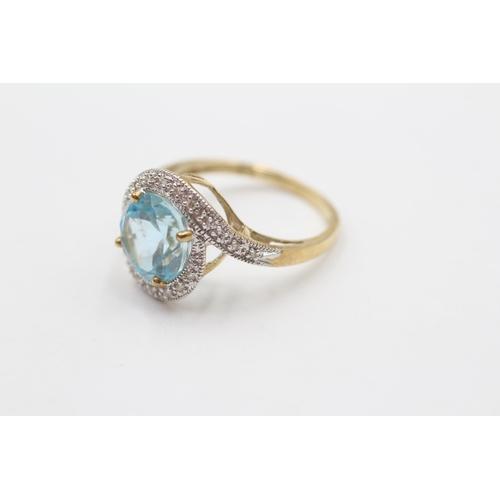 68 - 9ct Gold Blue Topaz & Diamond Halo Twist Setting Ring (3.8g) size Q