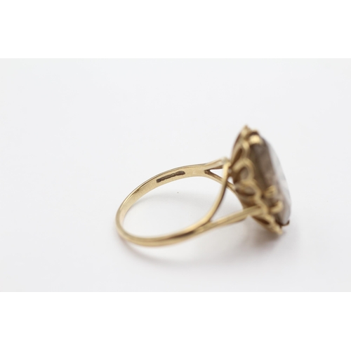 114 - 9ct Gold Smoky Quartz Oval Cut Ornate Openwork Prong Basket Set Cocktail Ring (5.9g) size T