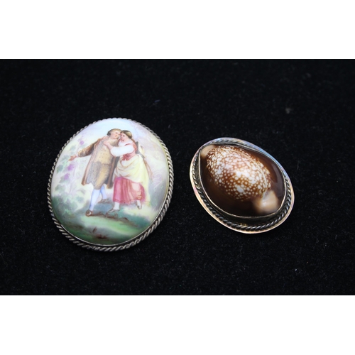 175 - Two Brooches Including A Cowrie Shell And A Porcelain Portrait (45g)