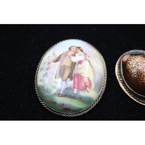 175 - Two Brooches Including A Cowrie Shell And A Porcelain Portrait (45g)