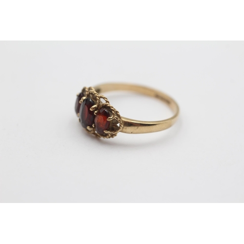 35 - 9ct Gold Garnet Three Stone Ring (1.7g) Size L