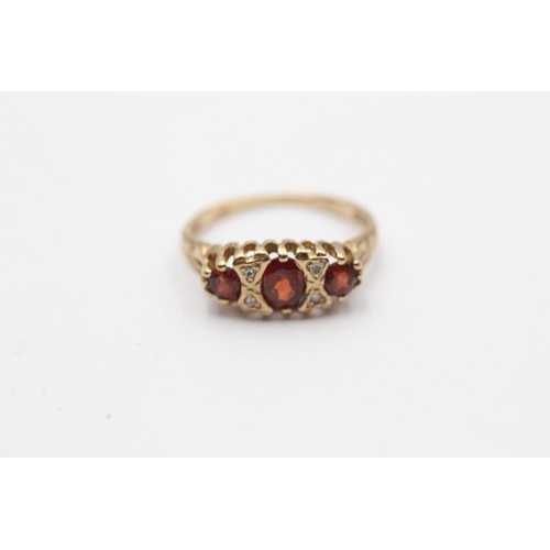 97 - 9ct Gold Diamond & Garnet Seven Stone Ring (1.6g) Size J