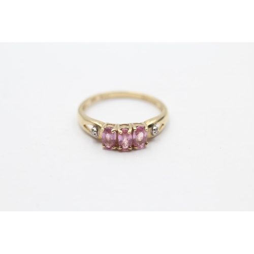 98 - 9ct Gold Pink Sapphire Three Stone Ring With Diamond Sides (1.8g) Size O