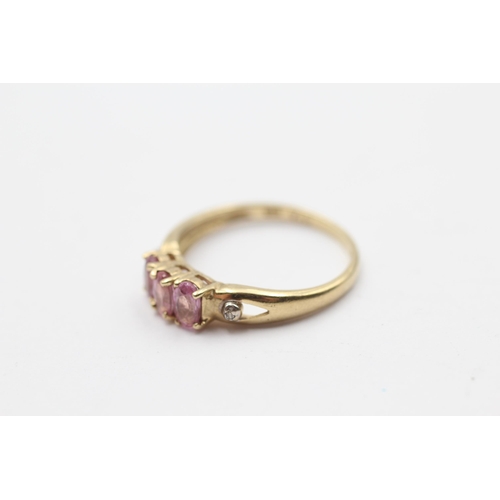 98 - 9ct Gold Pink Sapphire Three Stone Ring With Diamond Sides (1.8g) Size O