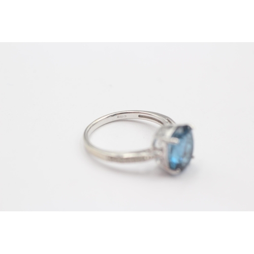 66 - 9ct White Gold Blue Topaz Single Stone Ring With Diamond Set Shank (3.3g) Size  N