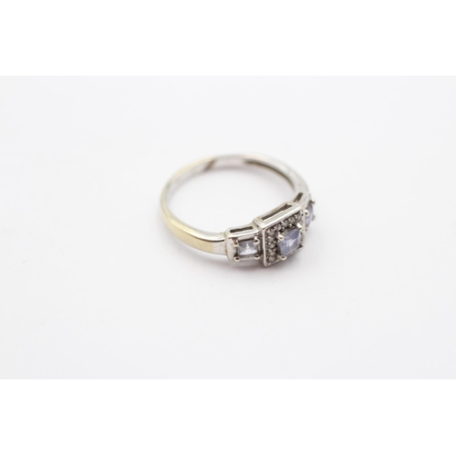55 - 9ct White Gold Tanzanite Three Stone Ring With Diamond Surround (2.1g) Size  K