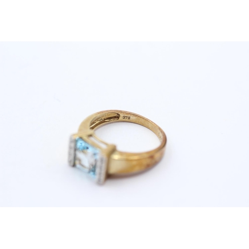 7 - 9ct Gold Blue Topaz Single Stone Ring With Diamond Sides (3.8g) Size  O 1/2