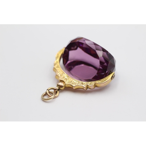 34 - 9ct Gold Victorian Purple Glass Set Spinning Fob (19.9g)