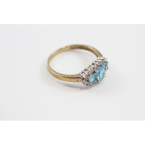 49 - 9ct Gold Blue Topaz & Diamond Three Stone Halo Dress Ring (2.3g) Size  P