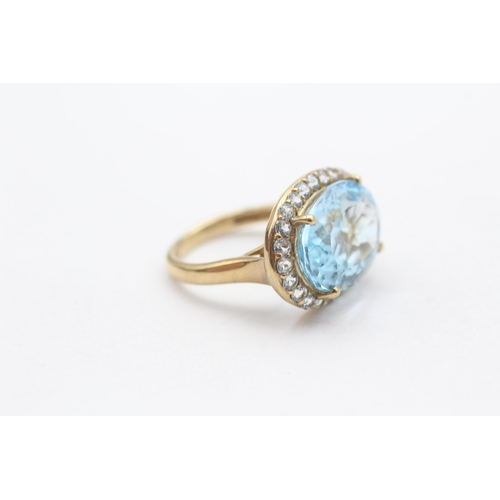 114 - 9ct Gold Blue Topaz Halo Cocktail Ring (5.2g) Size  K