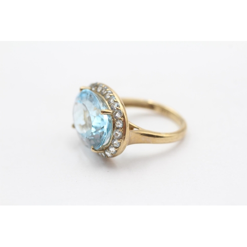 114 - 9ct Gold Blue Topaz Halo Cocktail Ring (5.2g) Size  K