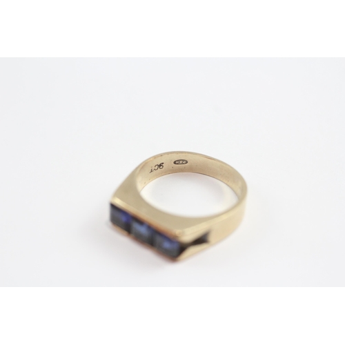 141 - 9ct Gold Synthetic Sapphire Channel Setting Ring (4.9g) Size  N