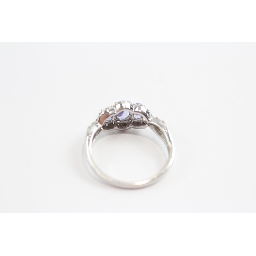 93 - 9ct White Gold Tanzanite Three Stone Ring With Diamond Frame (1.9g) Size  M