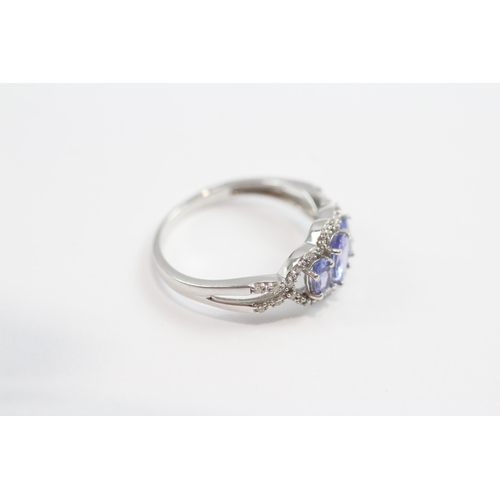 93 - 9ct White Gold Tanzanite Three Stone Ring With Diamond Frame (1.9g) Size  M