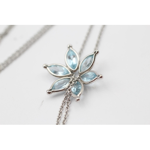 168 - 18ct White Gold Blue Topaz Floral Pendant Necklace (6.6g)